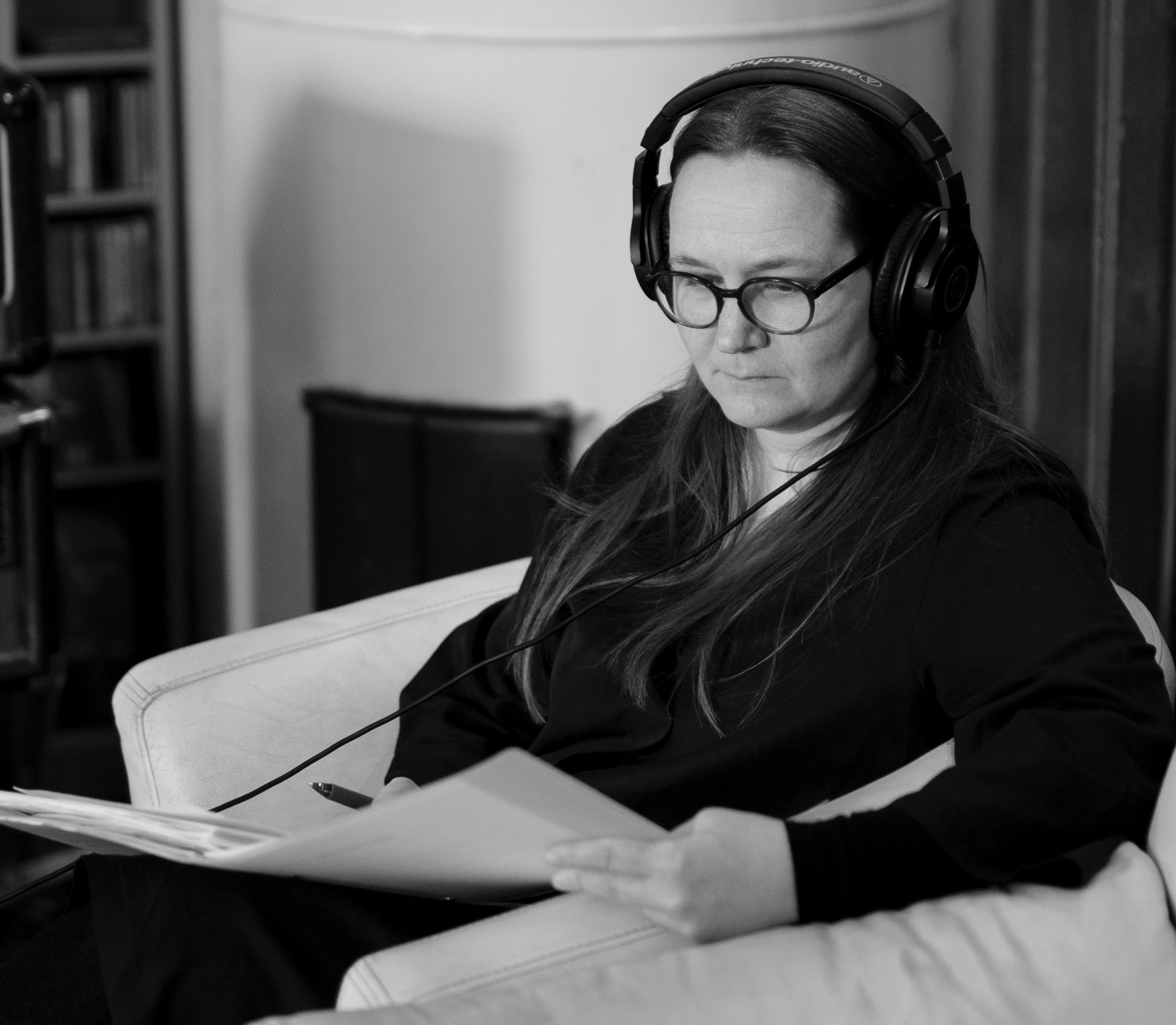 Kvinne med øreklokker som studerer ett ark